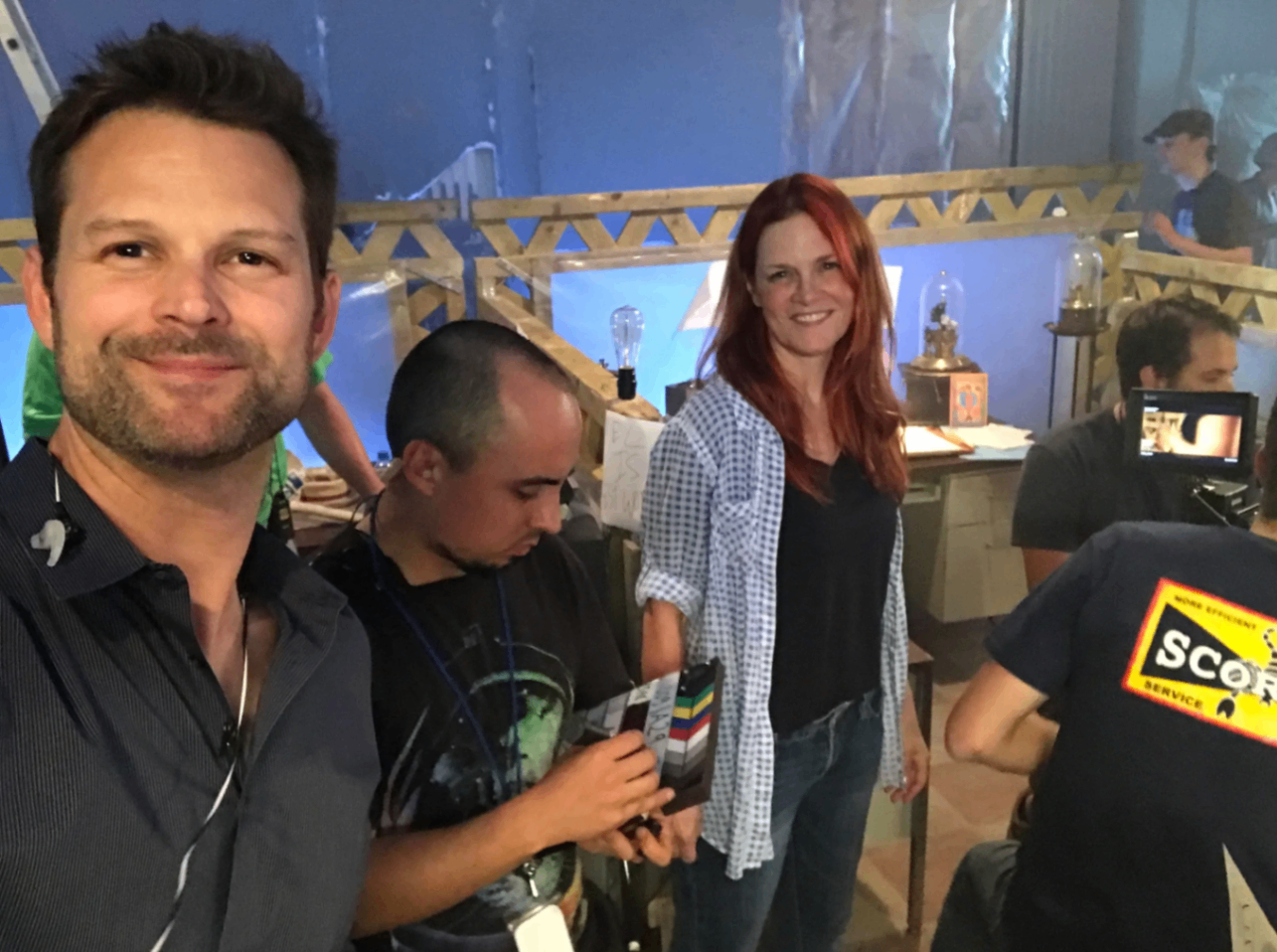 Anne Welles and Chris smiling on set
